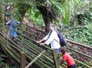 Crossing a bamboo bridge on the trek to Millenium Cave.  The local village owns the land and the cave.  Tour proceeds benefit the school.